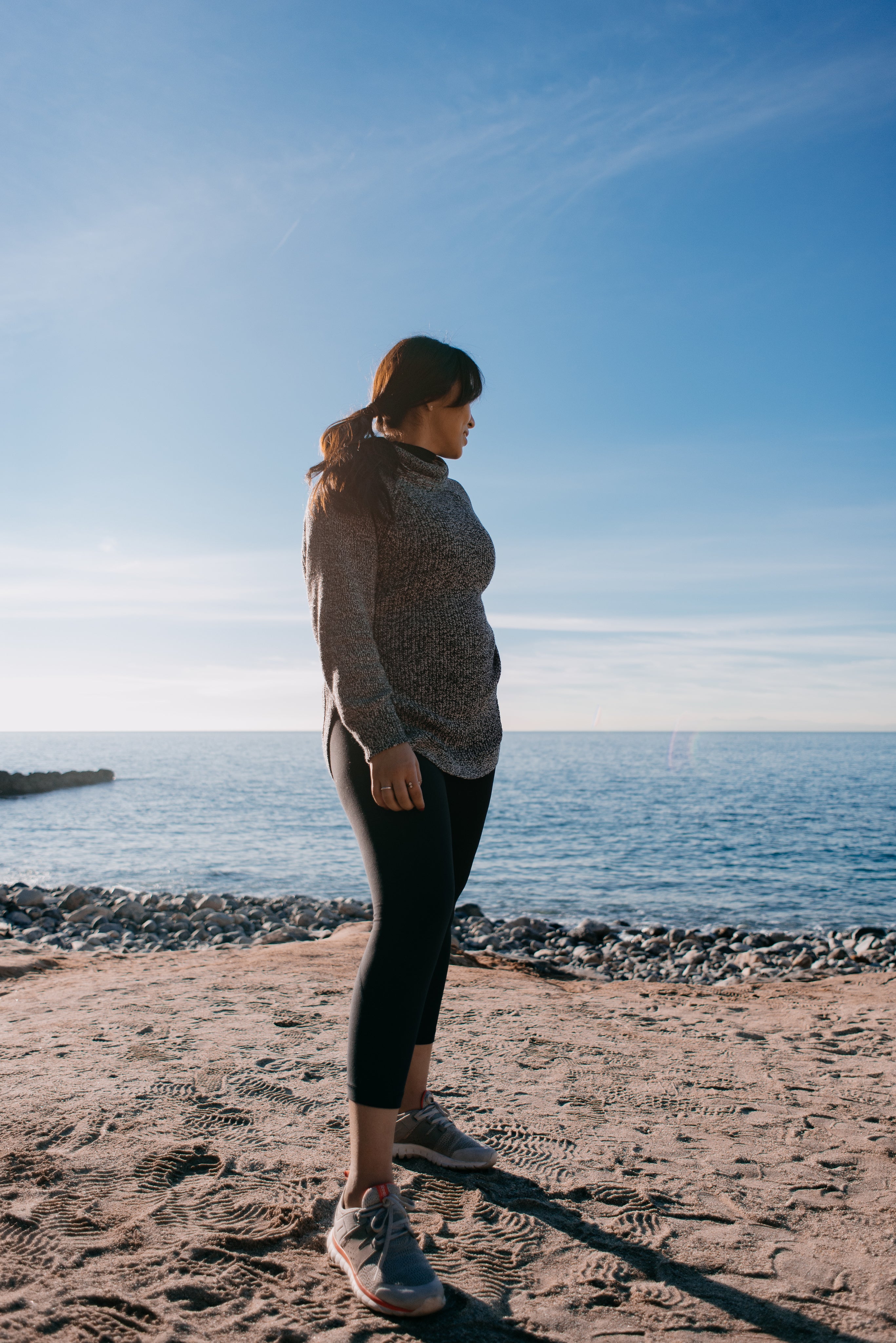 files/woman-glances-back-at-the-sea-behind-her-in-the-morning-light.jpg